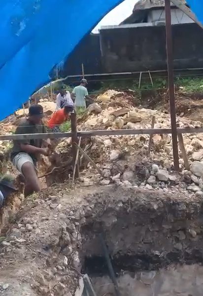 Workers excavating limestone foundations